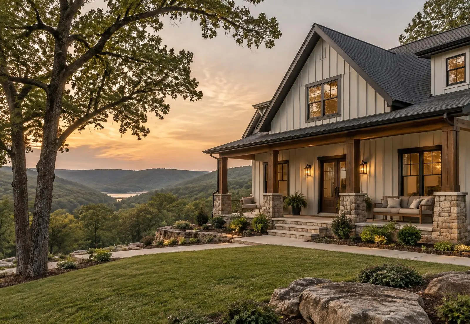 Craftsman-style home with a front porch overlooking wooded Arkansas hills at sunset